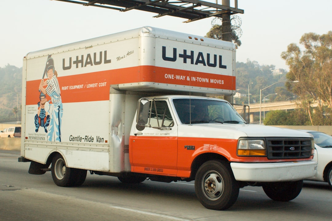 why-choose-us a-u-haul-truck-driving-on-a-highway-axfg4brgts0